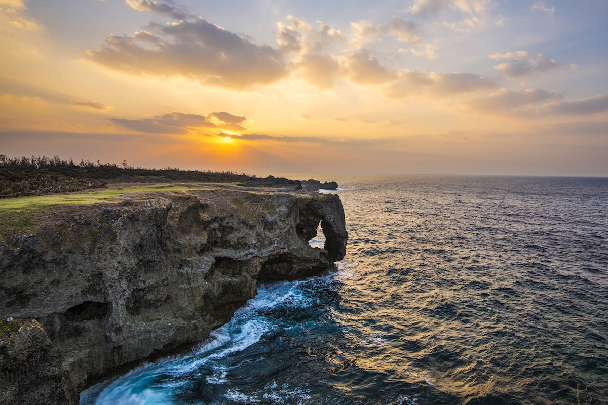 view of a coastline, water, and a sunset